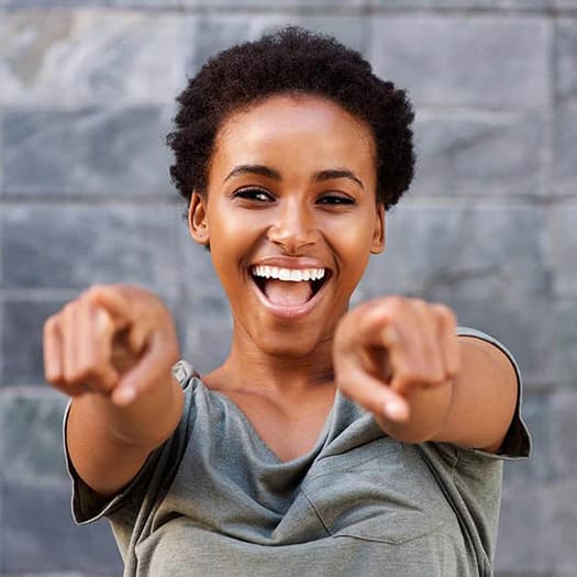 Smiling Woman Pointing at Camera