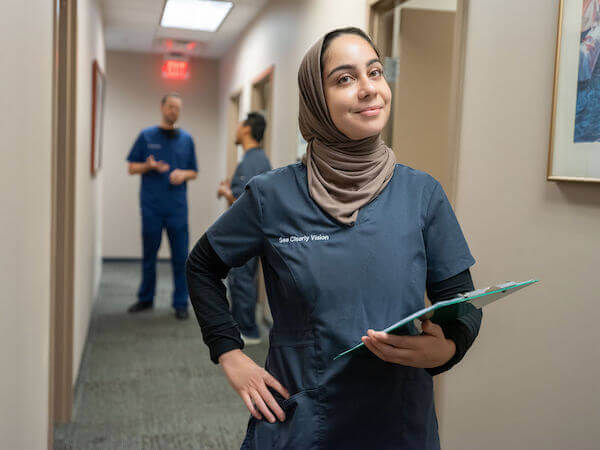 Tech in hallway with clipboard