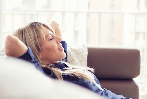 Woman reclining happily on couch