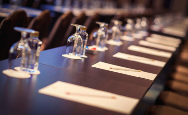 Close up of a long table set up for a seminar