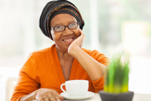 Senior woman wearing glasses and drinking coffee