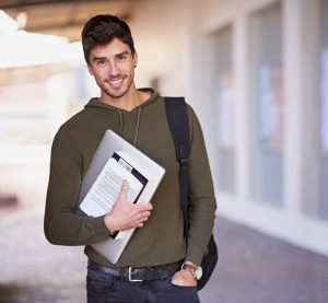 Cropped portrait of a handsome young man standing outside while on campus