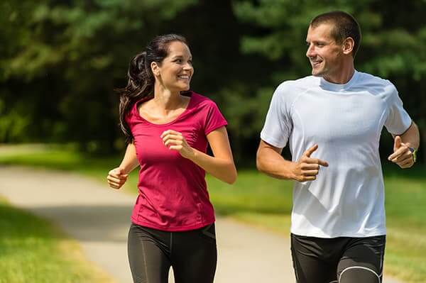 Young couple without glasses jogging