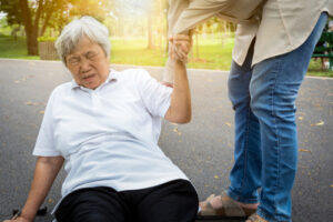 woman trying to get up from falling