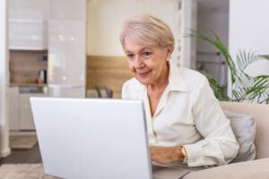 Woman smiling at laptop