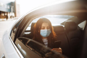 Woman in car with mask