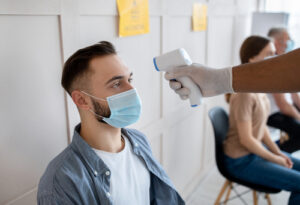 Man getting his temperature taken