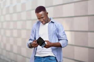 Man looking into wallet