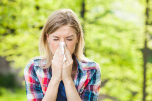 Woman blowing nose